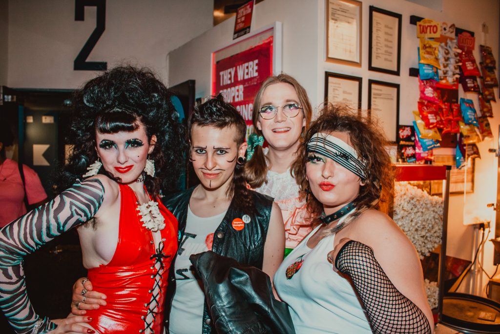 Audience members posing in costume for the Queer Horror Nights 50th Anniversary screening of FEMALE TROUBLE at Rio Cinema (13 July 2024).