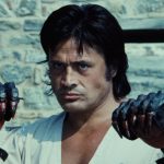 This is a film still from THE SWORD AND THE CLAW dir Natuk Baytan (1975) showing a Turkish fighter with claws for hands standing in front of a castle wall.